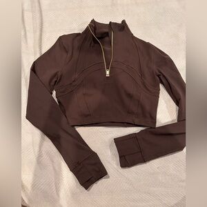 Define cropped half zip *luon*, never worn, but I did rip off the tag.